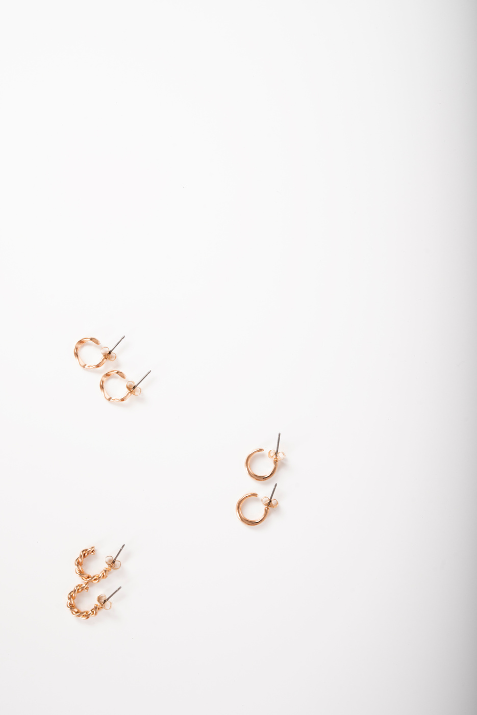 Photo of earrings top view on white background