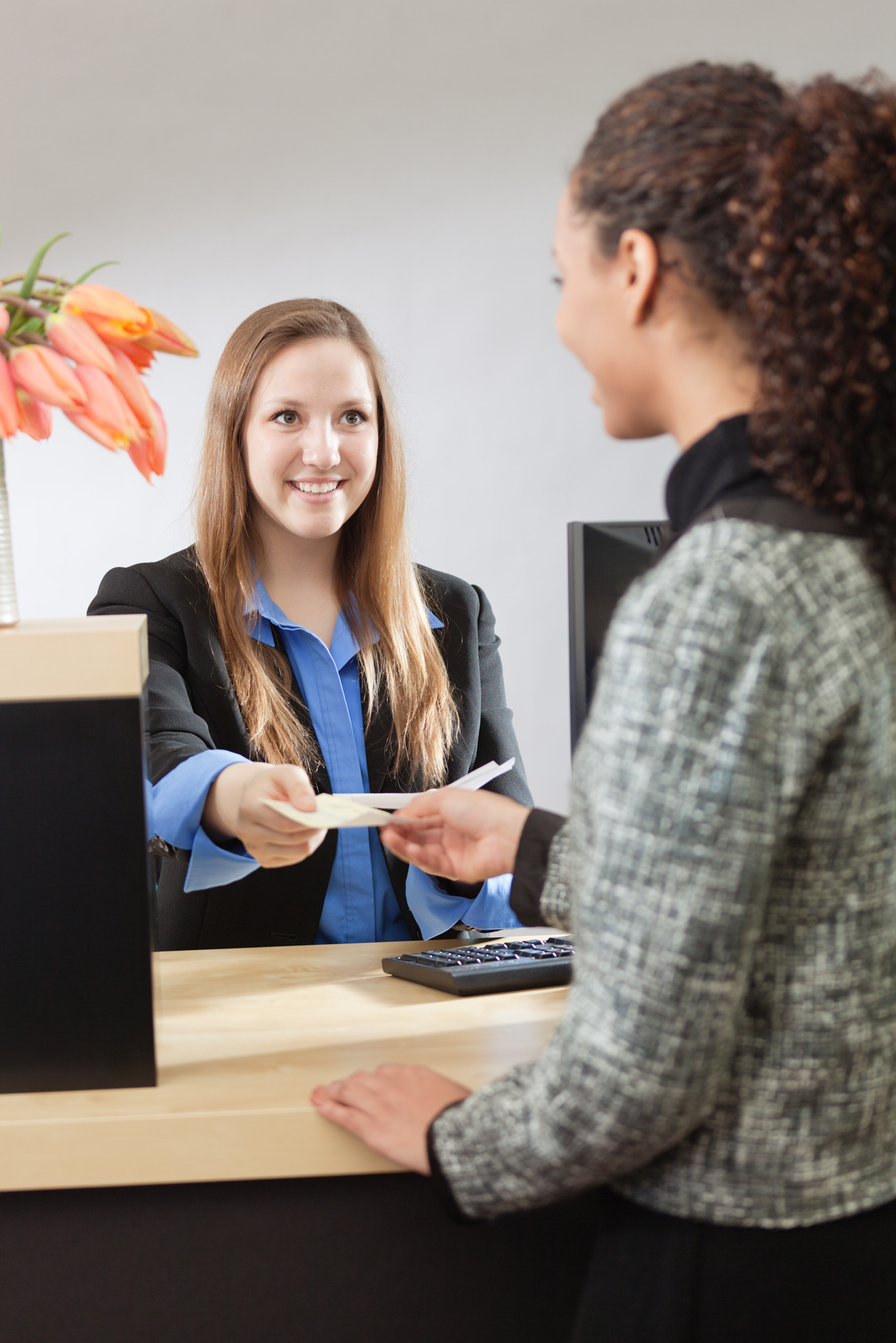 Bank Teller Working with Customer at Retail Bank